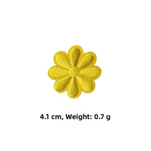 Detailed close-up of 4.1cm yellow daisy embroidered iron-on patch with textured stitching