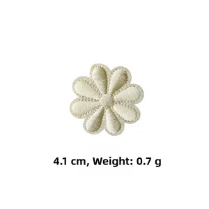 Detail view of small white daisy embroidery patch measuring 4.1cm with 0.7g weight