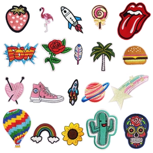 Detail of assorted cartoon embroidery patches including stars, rainbows and food items