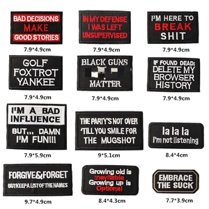 Detailed embroidery texture of black tactical patches with various English slogans