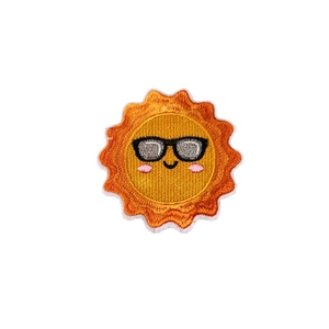 Smiling sun embroidery patch with black sunglasses and bright orange flame border