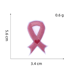 Close-up of pink ribbon embroidery patch with red heart and 5.6cm height measurement