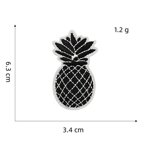 Detail showing dimensions of pineapple embroidery patch measuring 6.3 cm x 3.4 cm