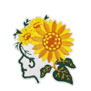 Embroidered sunflower patches for clothing with green leaf details on white background