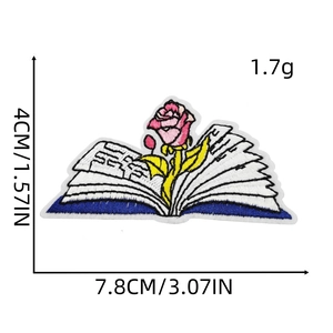 Embroidered pink rose growing from an open book patch with precise measurements