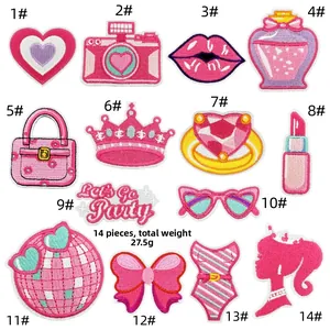 Detailed embroidery texture of pink cartoon patches including hearts and icons