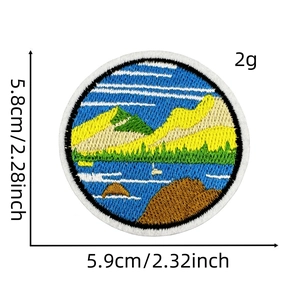 Detail of round nature landscape embroidery patch featuring forests and mountains