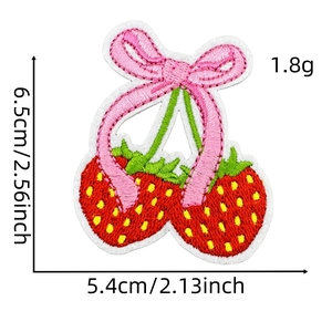 Cartoon strawberry embroidery patch with pink bow and green leaves on white background