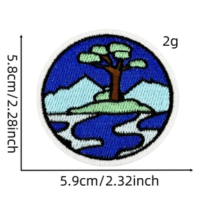 Detailed view of nature embroidery patch featuring mountains, lake and a pine tree