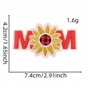 Close-up of embroidered MOM patch with sunflower detail and iron-on backing texture