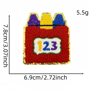 Detailed view of red chenille crayon patch with gold glitter edge and 123 embroidery