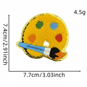 Detailed chenille patch of a yellow art palette with gold trim and paintbrush