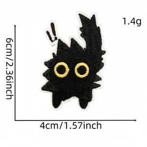 Detail showing embroidered black cat patch with yellow eyes measuring 6cm x 4cm