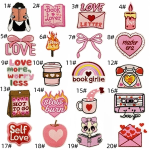 Macro view of 20 assorted pink heart and coffee embroidered iron-on patches with precise edges