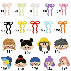 Close-up of assorted mini cartoon characters and colorful bow embroidery patches