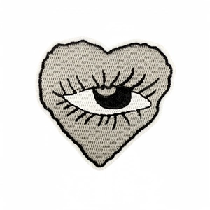 Y2K heart-shaped embroidery patch with central eye pattern and black eyelashes on white back