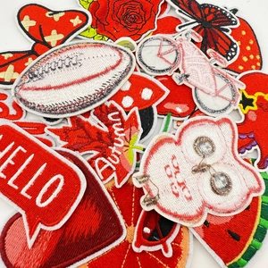Detail of red series embroidered iron-on patches with various fruit and floral designs