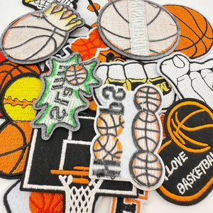 Close-up of basketball embroidery patches with vivid thread details on white surface