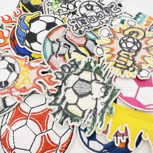 Detailed close-up of various colorful embroidered soccer ball patches with SOCCER text designs