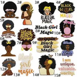 Detailed macro showing various Black Girl Magic embroidered iron-on patches with afro styles