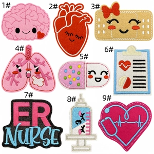 Detailed close-up showing nine cute cartoon medical embroidery patches on white background