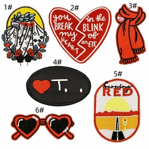 Detail view showing six red heart embroidery patches with intricate stitching patterns