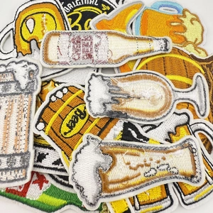 Close-up of beer mugs and bottles embroidered patches with vibrant yellow and white stitching