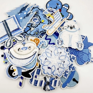 Detailed collection of blue and white winter themed embroidered patches for clothing