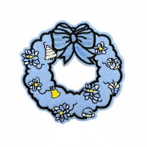 Blue snowman wreath embroidery patch with bow, flowers, and bells for clothing