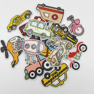Detailed macro view of colorful cartoon vehicle embroidery patches with white borders