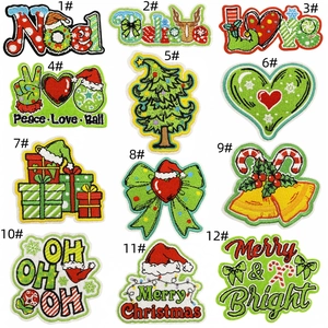 Close-up of Christmas embroidery patches including Santa hats and trees on white backdrop