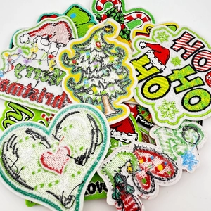 Macro shot of assorted Christmas embroidery patches with Santa and tree patterns