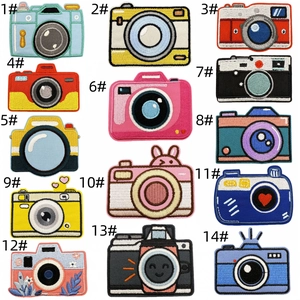 Detailed embroidery view of 14 cartoon camera iron-on patches with neat stitching