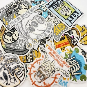 Detail of assorted punk skull and butterfly embroidery patches with iron-on backing