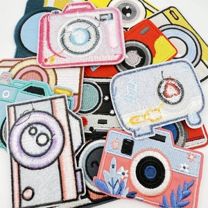 Detailed close-up showing colorful camera embroidery patches with fine thread textures