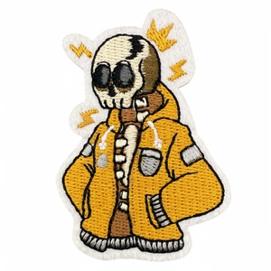 Embroidered cartoon skull patch in yellow hoodie with lightning details for clothing