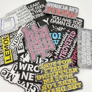 Close-up of assorted embroidered patches with math slogans for clothing and bags