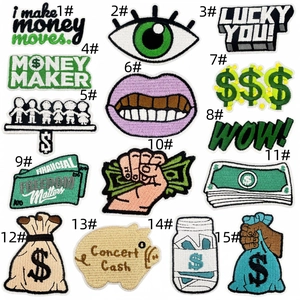 Close-up detail of money theme embroidery patches showing fine needlework and stitching