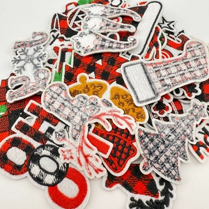 Detailed macro view showing diverse Christmas themed embroidery patches with various holiday patterns