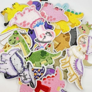 Detailed view of colorful cartoon dinosaur embroidery patches with fine needlework textures