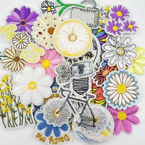 Close-up of vibrant daisy floral embroidery patches with detailed stitching texture