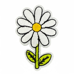 Colorful daisy flower embroidery patch with white petals and green leaves on white background