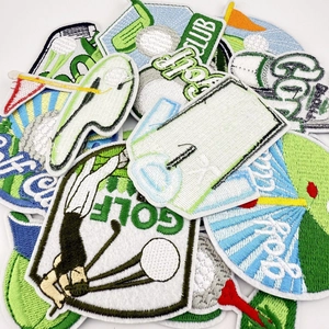Close-up of various golf embroidery patches with balls, clubs and green flags