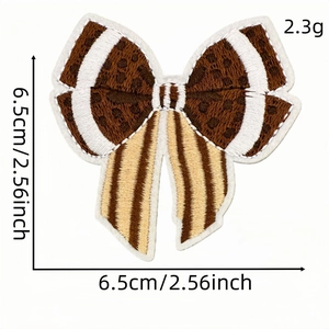 Leopard print bow embroidery patch with white stitching detail, 6.5cm decorative badge