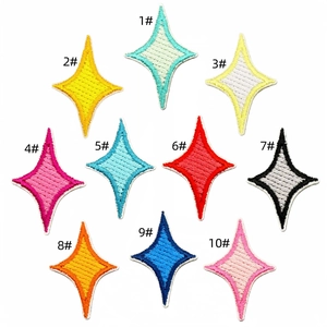 Detail of multi-colored star embroidery patches with fine stitching on white background