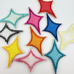 Detailed macro view of colorful star-shaped embroidered patches with neat stitched edges