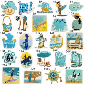 Detailed close-up of 24 blue coastal cowgirl embroidery patches with fine needlework texture