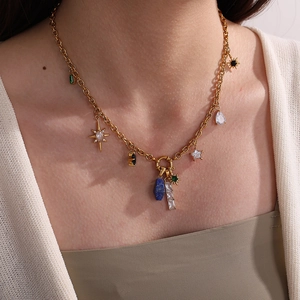 Collana bohémien placcata oro 18K con ciondoli a stella e gemme colorate su una modella
