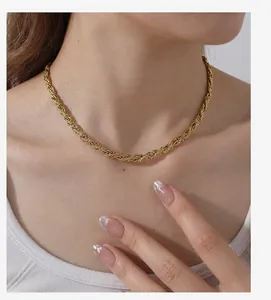 Detailopname van een vintage 18k vergulde gevlochten touwketting om een vrouwenhals
