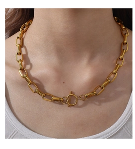 Detailopname van een gouden grove ketting met vintage OT-sluiting bij een vrouwelijk model